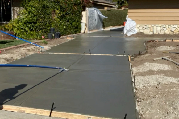 this image shows concrete driveway in Cypress, California